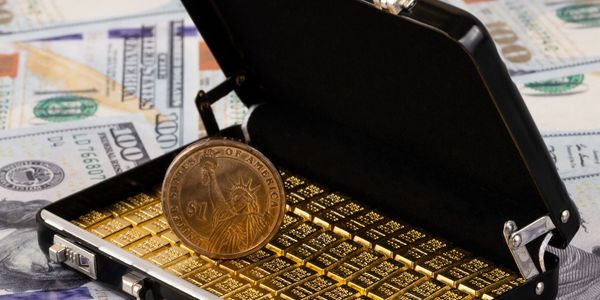Mini briefcase filled with gold bars and a US dollar coin on top.