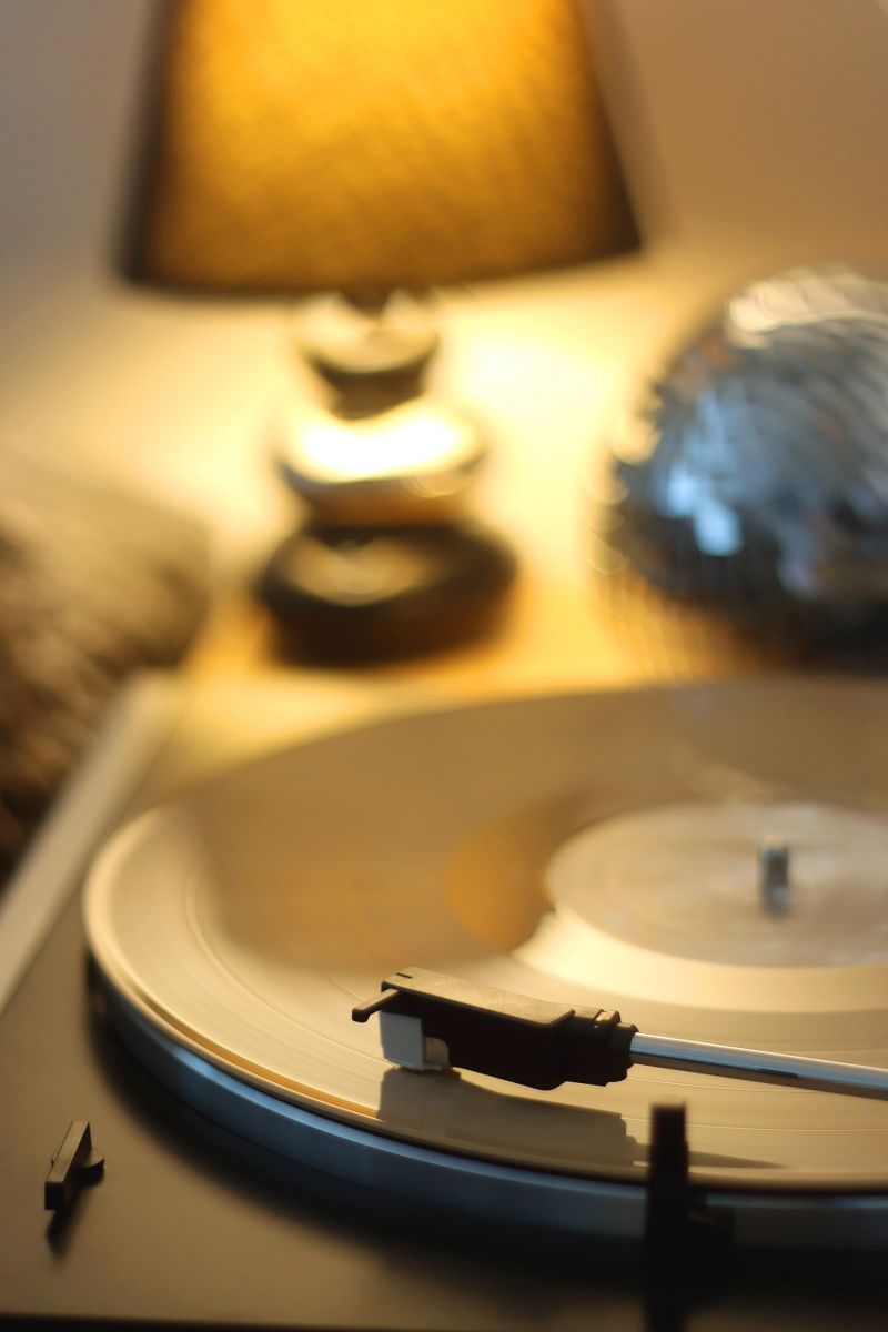Playing vinyl record on the gramophone at home. Selective focus.