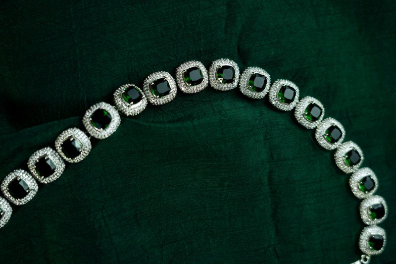 A luxury silver necklace and earrings displayed in soft light, perfect for wedding or fashion branding.