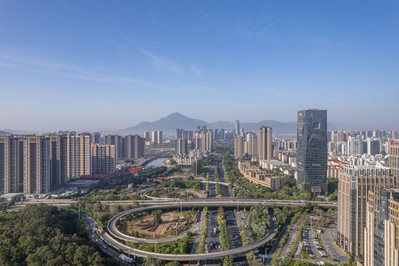 An aerial view of modern city architecture and road network on a clear day. Putian City, Fujian Province.