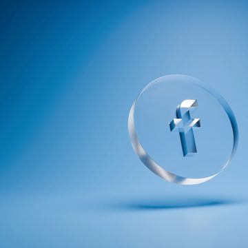 3D glass Facebook logo floating in blue space.