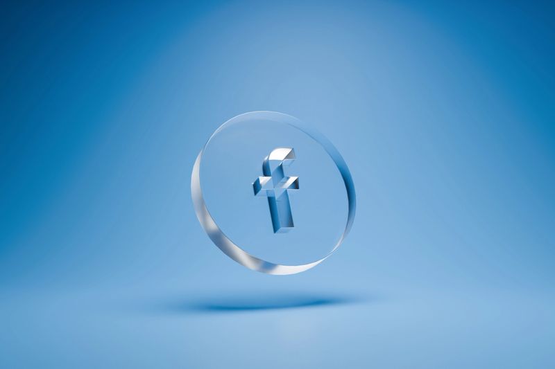 Crystal Clear Glass Facebook Logo Icon on a Light Blue Background Representing Social Media, Global Connectivity, and Digital Networking.