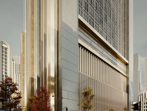 Urban street corner with tall, golden-accented buildings and vintage cars.