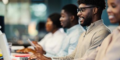 People working together at computers in an office.
