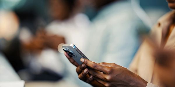 Person holding a smartphone indoors.