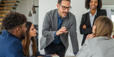 A team engaged in a lively business meeting around a table.