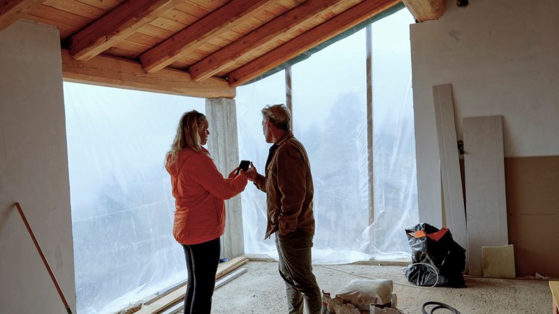 Mature couple check out new home construction, vacation home in the Alps, Piedmont