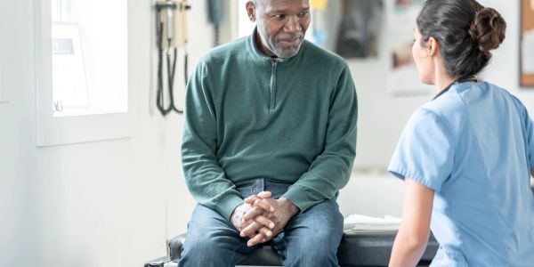 Doctor consulting a patient in a clinical setting.