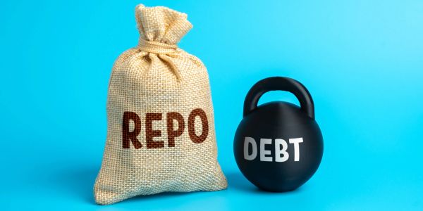 A bag labeled REPO and a weight labeled DEBT.