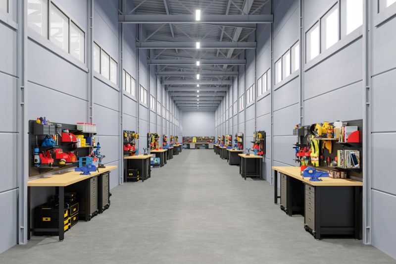 Modern industrial workshop with organized workbenches and tools in a spacious warehouse