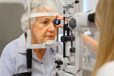 Optometrist performing eye exam.