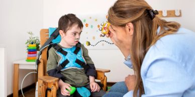 Therapist engaging with a child with disabilities.