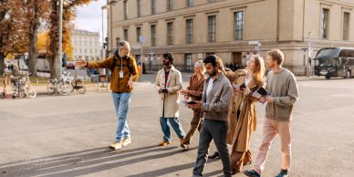 Tour guide leads group on city walk.