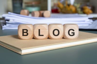 Wooden blocks spelling BLOG on a notebook.