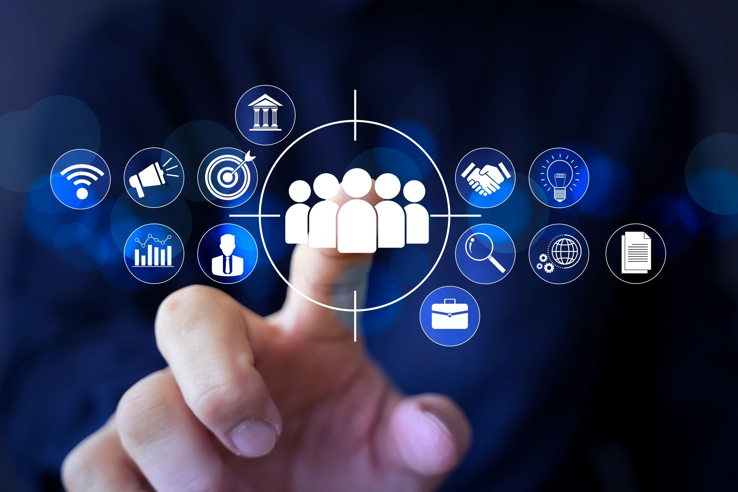 Hand pointing at digital icons representing teamwork and business concepts.