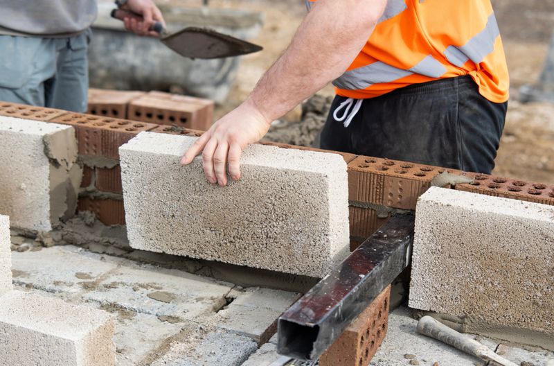 Expert mason laying bricks for a durable wall construction