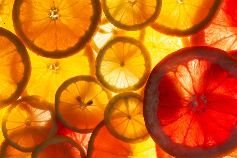 This vibrant image of citrus slices, including oranges and grapefruit, is arranged to create an eye-catching and refreshing visual, perfect for culinary or health-related themes emphasizing freshness and zest.