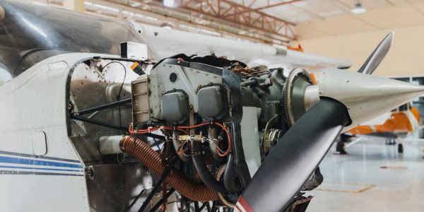 Close-up of a small airplane engine with an exposed propeller.