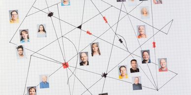 A network of connected faces on graph paper with lines and marks.