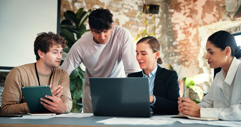 Office meeting, tablet or team with laptop in marketing agency, content release schedule or agenda. Brand promotion, collaboration and people brainstorming with tech, discussion and campaign calendar