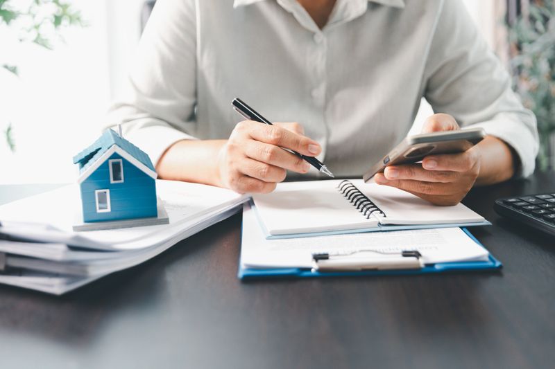 Real estate agent agree to buy home to clients agency office. House model, real estate agent, customer discussing for contract to buy house, insurance, loan real estate background. Concept agreement.