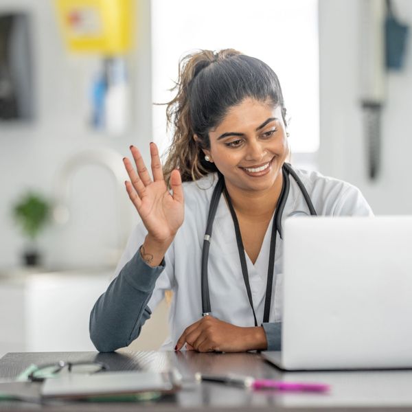 Friendly Northstar Telehealth Provider waving hello during a s ecure virtual doctor visit