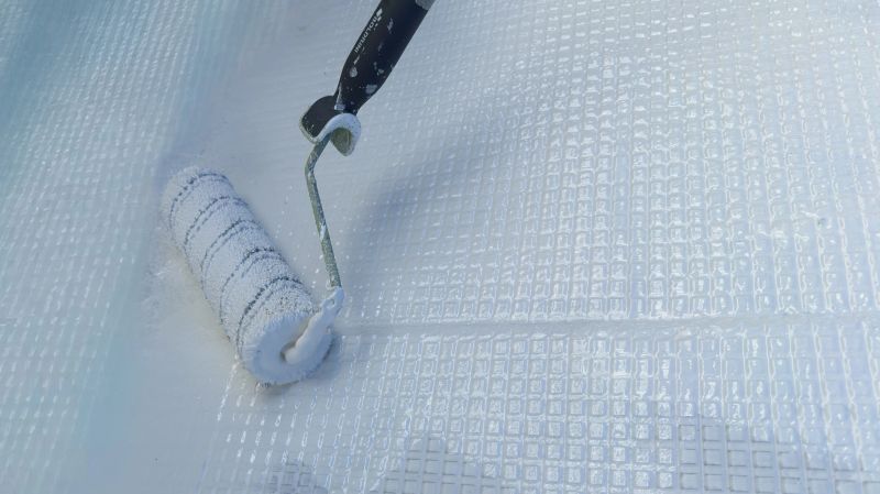 Painting waterproof resin on fiberglass mesh with roller tool
