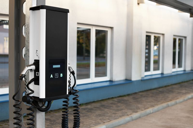 Electric vehicle charging station in a parking lot. Modern design with multiple charging ports. Clean energy concept for sustainable transportation.