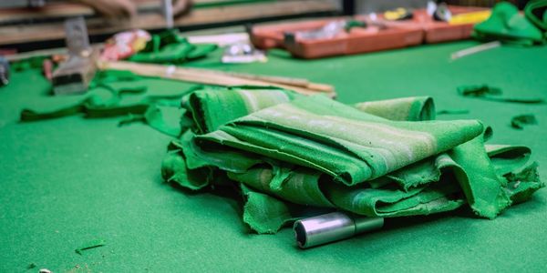 Snooker table cloth replacement.  Old snooker cloth being removed.
