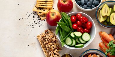 A healthy snack spread with fruits, nuts, and vegetables.