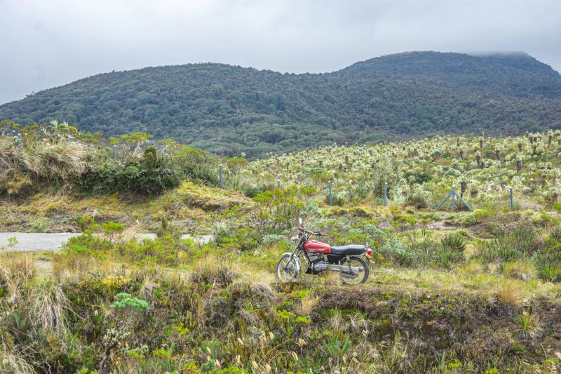 A motorcycle parked in the scenic Puracé landscape, featuring frailejones and rolling hills in Popayán, Cauca, Colombia.