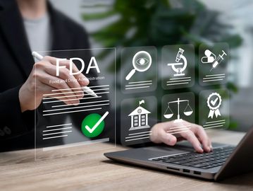 Person interacting with FDA virtual interface on a laptop.