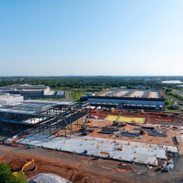 Construction site with building frameworks and equipment.
