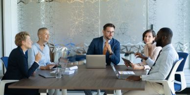 Five professionals having a meeting in a conference room.