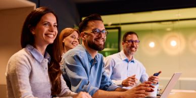 Group of colleagues smiling in a meeting.