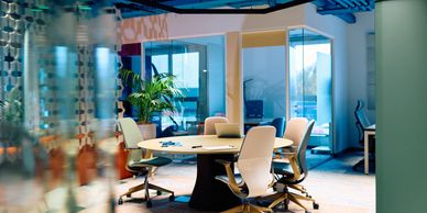 Modern office meeting room with chairs around a table.