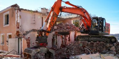Excavator demolishing a building.