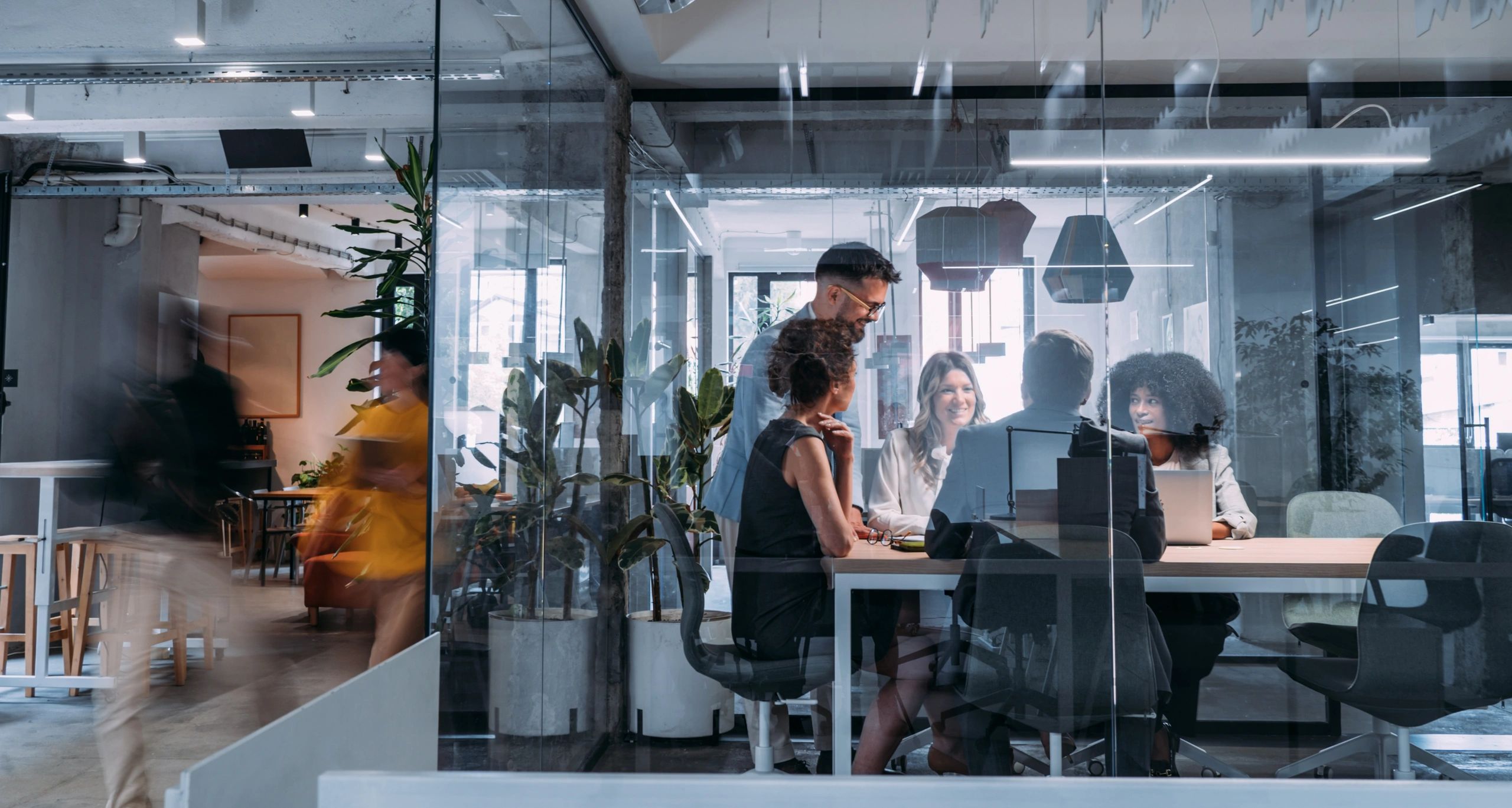 Team meeting in a modern glass office.