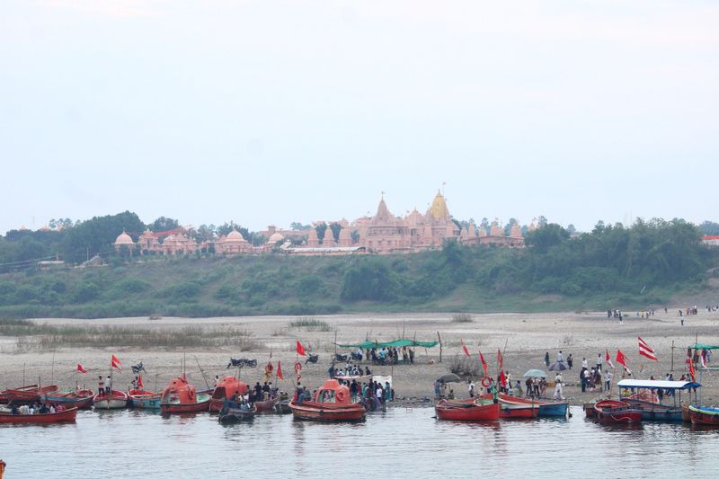 A beautiful riverbank of Narmada. Lots of boats for river crossing. Temple at the end of Valley.