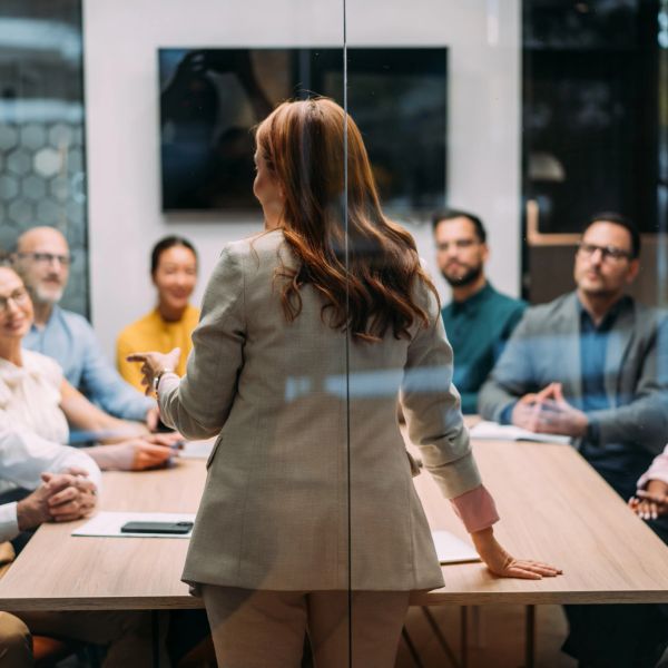 Woman leading a meeting with attentive colleagues.