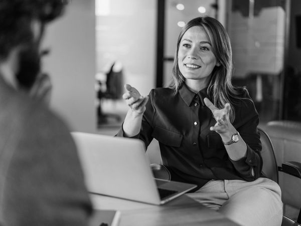 Woman explaining something during a meeting with a man.