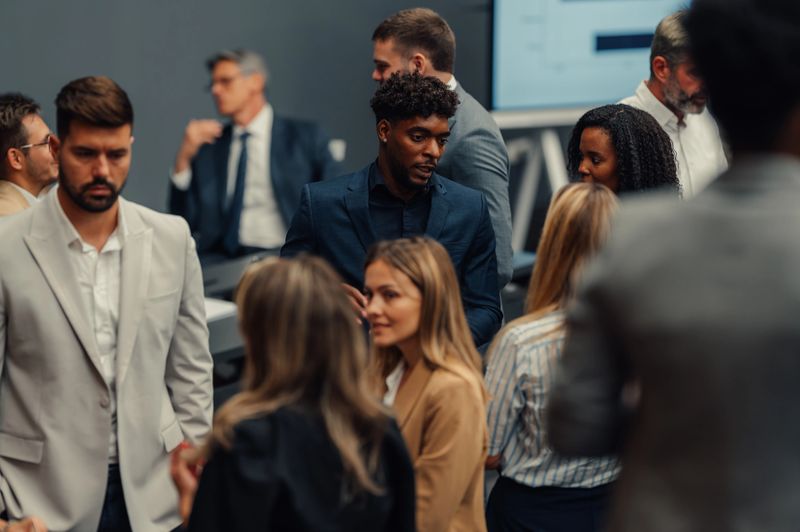 Diverse group of business people interacting and collaborating during a professional meeting or networking event