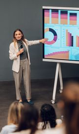 Woman giving a presentation with charts.