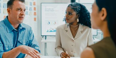 Three professionals engaged in a focused business discussion.