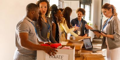 Volunteers sorting donated clothes in a bright community center.