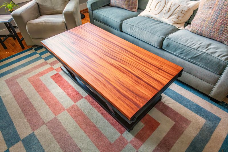 The top of a natural handcrafted wood and steel table in the family room of a home.