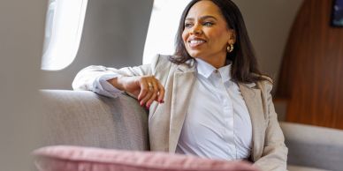 Confident woman relaxing on a sofa.