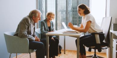 Young woman consulting elderly couple at office.