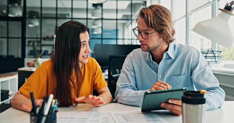 Business people, meeting and discussion with tablet in company, document and financial records. Technology, man and woman with paperwork for accounting report, budget planning or review with team