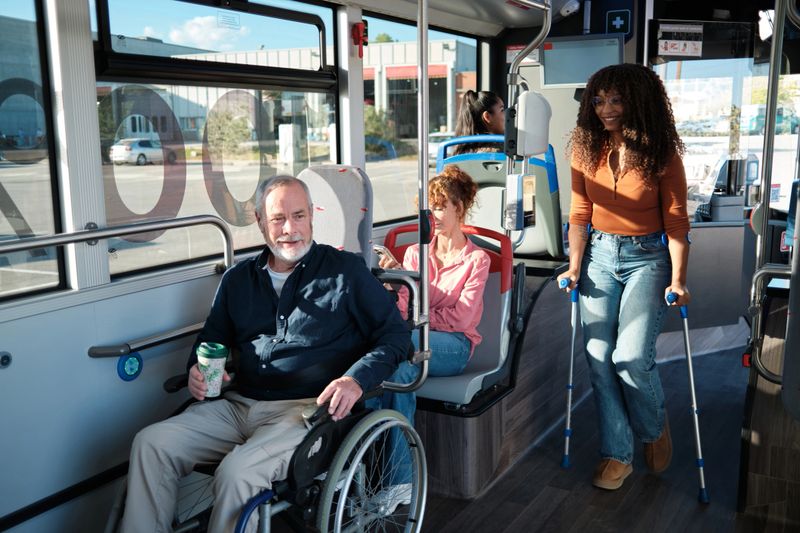 Diverse adults with disabilities using accessible public transportation, promoting inclusion and independence
